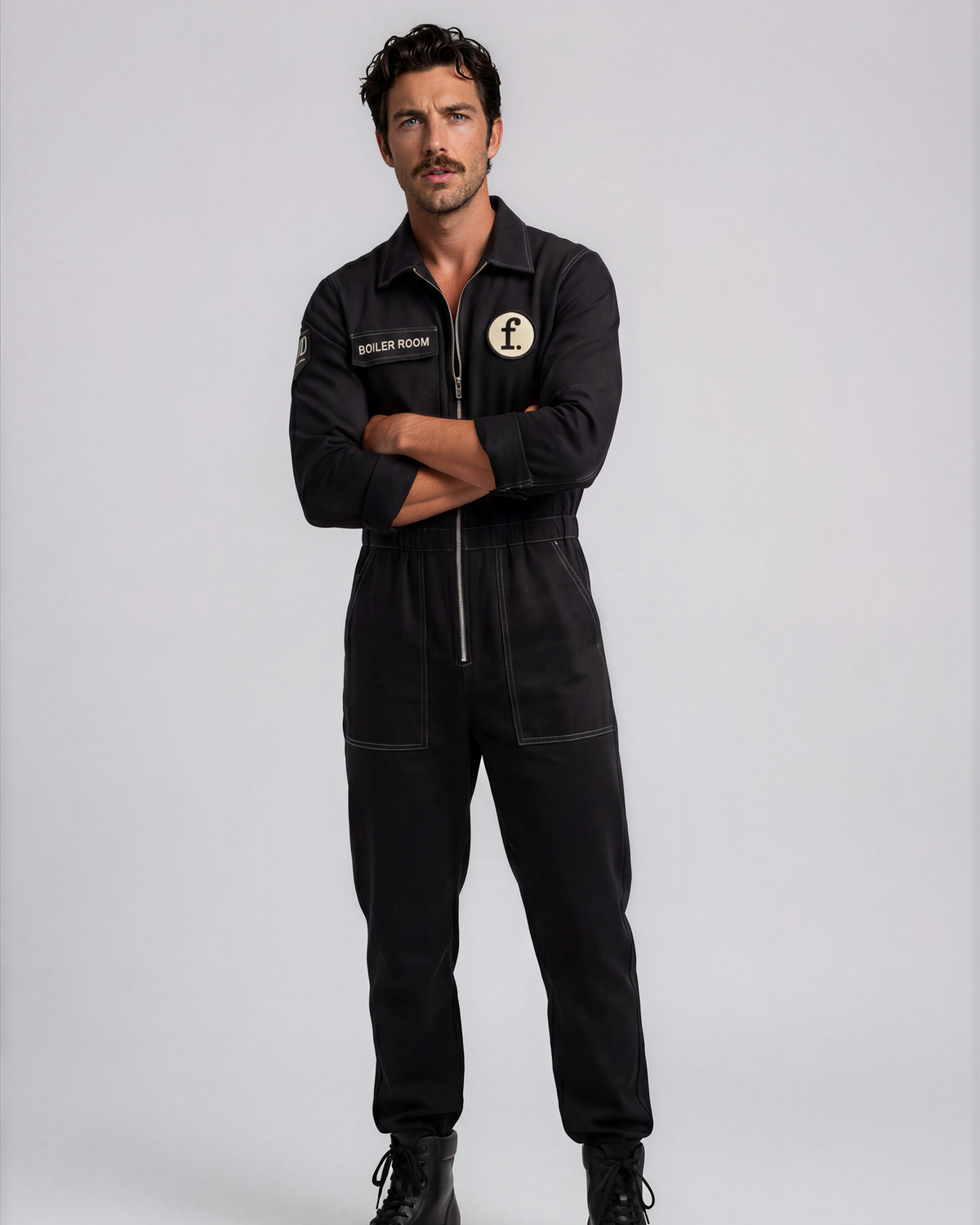 Man wearing a black jumpsuit with Foil Style patches on a white background