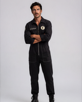 Man wearing a black jumpsuit with Foil Style patches on a white background