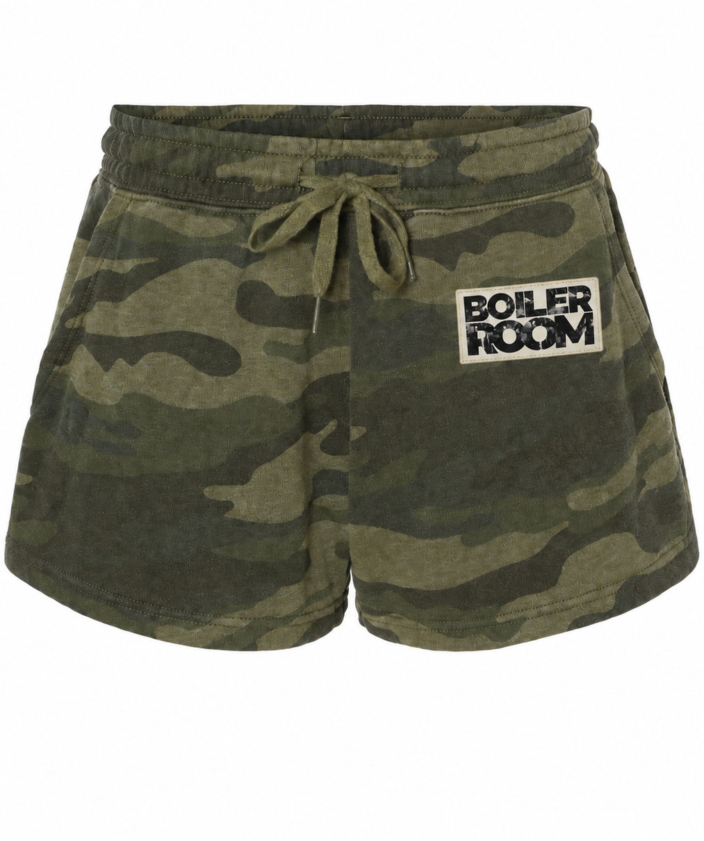 A pair of camouflage print lounge shorts with an elastic drawstring waist and a white 'BOILER ROOM' patch on the left hip, shown against a plain white background.