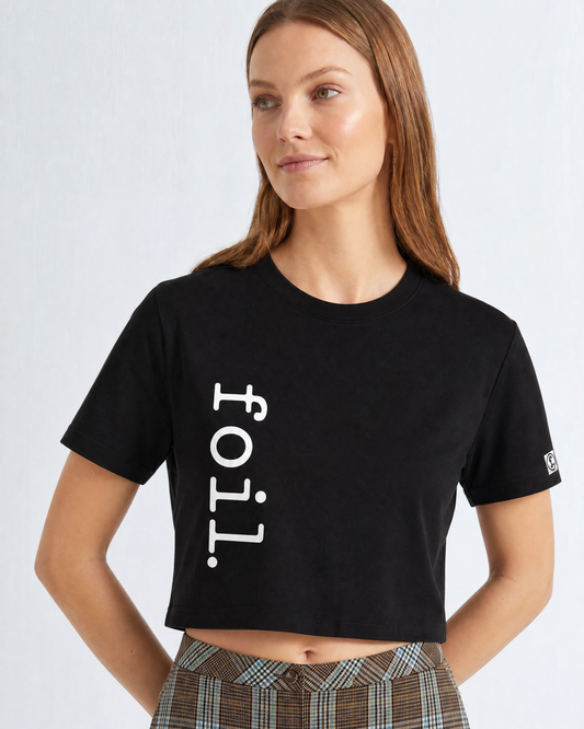 Woman wearing a black t-shirt with 'foil.' text on a white background