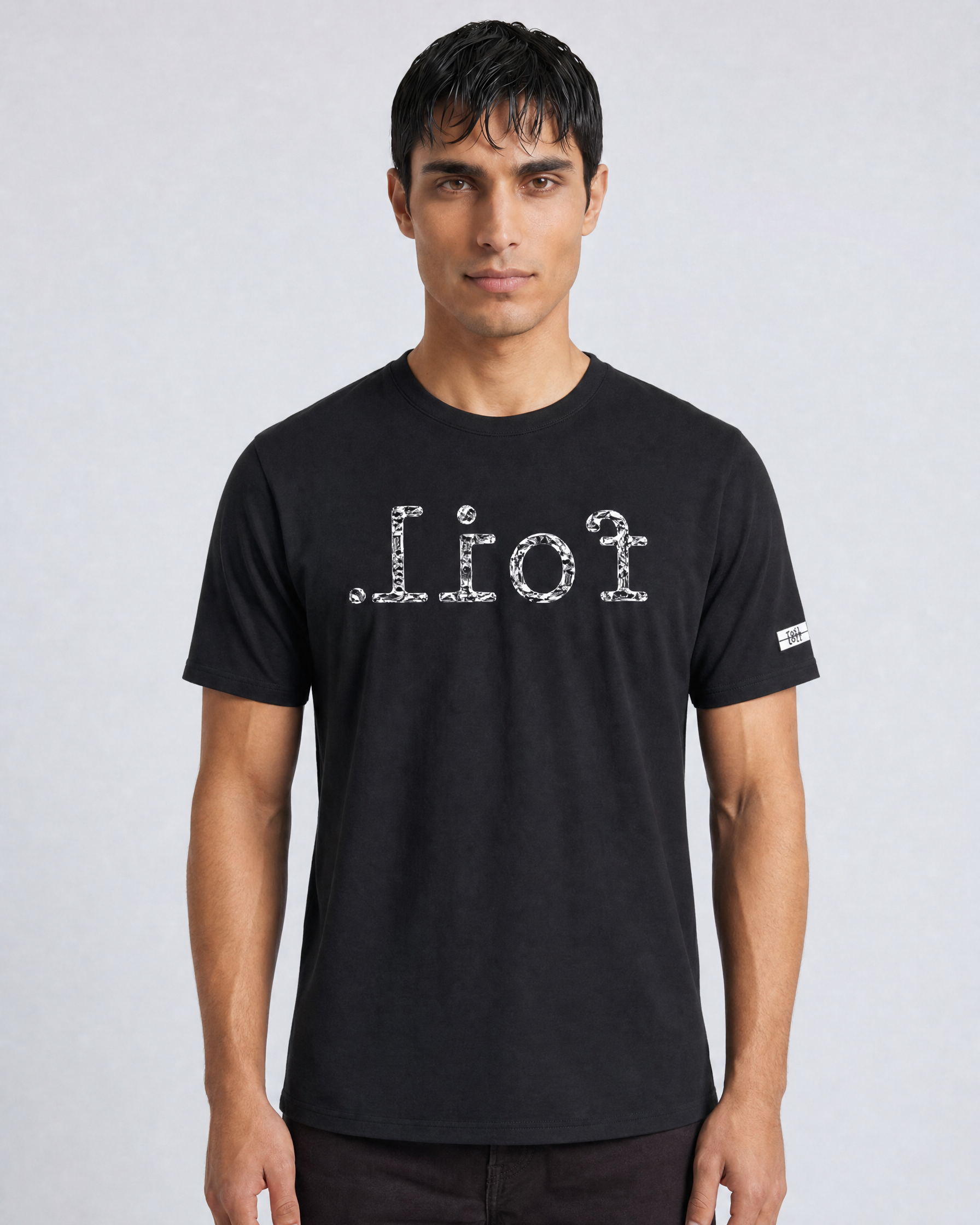 Man wearing a black t-shirt with white text on a light gray background