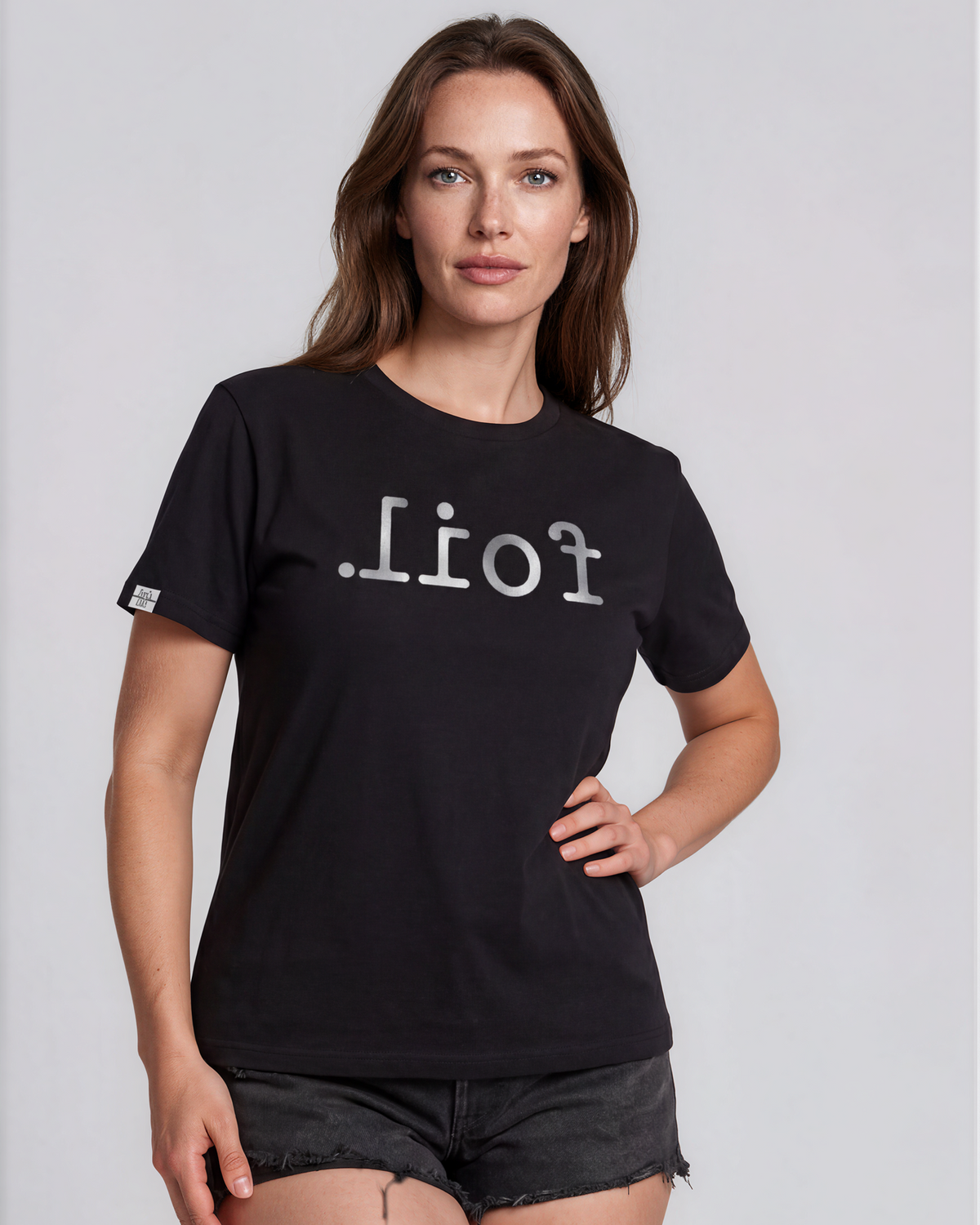 Woman wearing a black t-shirt with white text on a light gray background