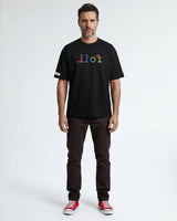 Man wearing a black t-shirt with colorful text on a white background