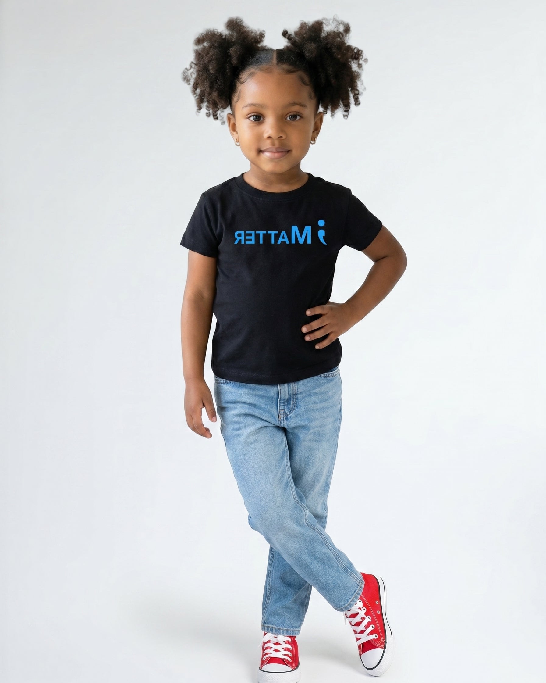 Child wearing a black t-shirt with 'MI MATTER' text on a white background